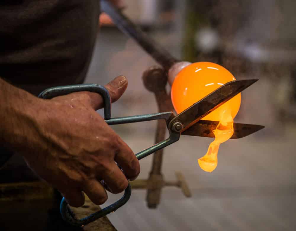 Man making glassware in a factory