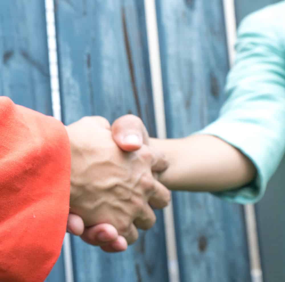 two women shaking hands